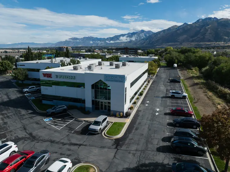 The Toothpillow Breathing and Sleep Center building in Draper, Utah, with the Wasatch mountains behind